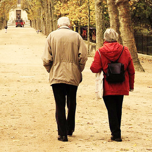 Zwei Senioren gehen im Park spazieren
