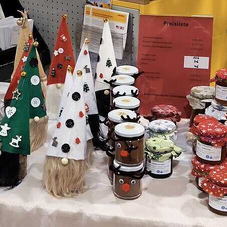 Selbst gefertigte Wichtel und Marmeladen an einem Weihnachtsstand